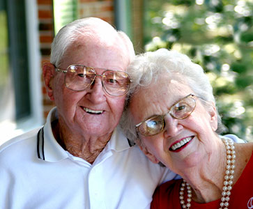 Photo of a man and woman smiling for a picture. Link to Life Stage Gift Planner Over Age 65 Situations.